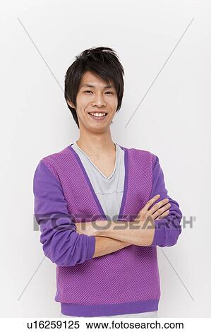 Young man with arms crossed View Large Photo Image Stock Photography - Young man with arms crossed. Fotosearch