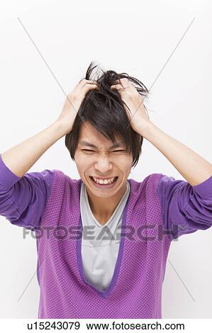 Young man with head in hands View Large Photo Image Stock Photo - Young man with head in hands. Fotosearch
