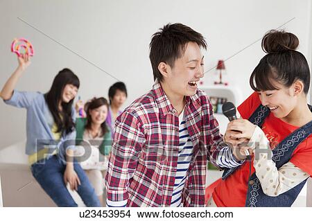Young people fighting over microphone View Large Photo Image Picture - Young people fighting over microphone. Fotosearch