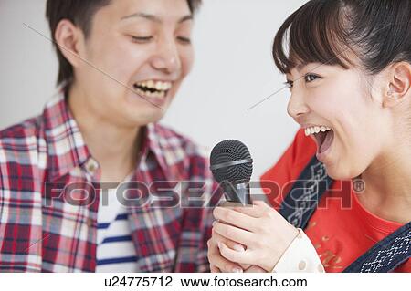 Young people singing karaoke View Large Photo Image Stock Image - Young people singing karaoke. Fotosearch