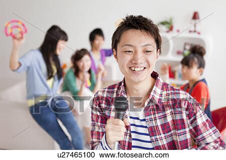 Young people singing karaoke View Large Photo Image Stock Image - Young people singing karaoke. Fotosearch