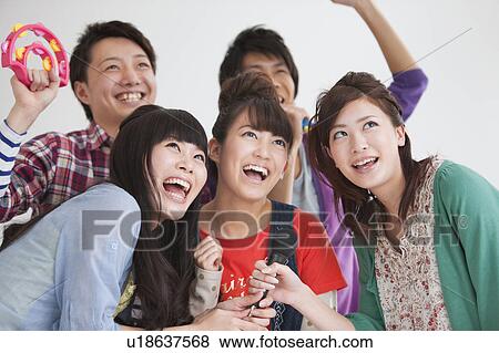 Young people singing karaoke View Large Photo Image Stock Photo - Young people singing karaoke. Fotosearch