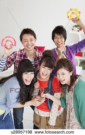 Stock Photo - Young people singing karaoke. Fotosearch