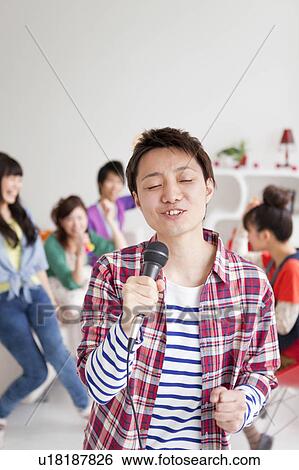Young people singing karaoke View Large Photo Image Stock Photograph - Young people singing karaoke. Fotosearch