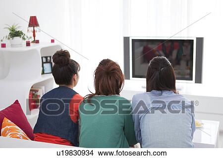 Young people watching TV View Large Photo Image Picture - Young people watching TV. Fotosearch