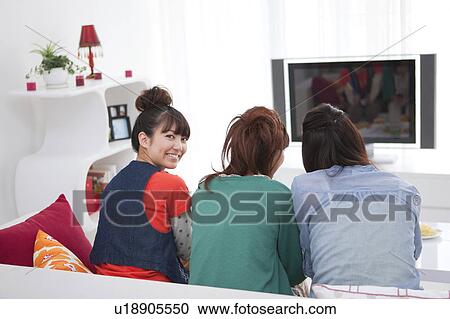 Young people watching TV View Large Photo Image Stock Image - Young people watching TV. Fotosearch