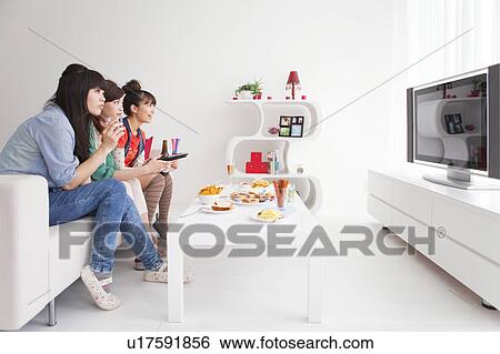 Young people watching TV View Large Photo Image Stock Photograph - Young people watching TV. Fotosearch