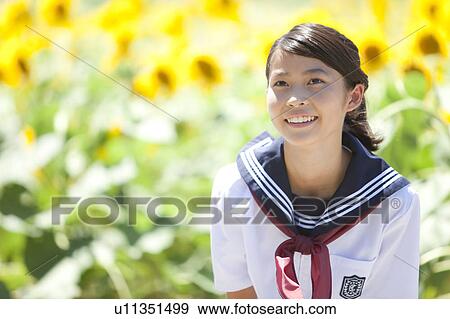 Stock Photo - Young Schoolgirl in Sunflower Field. Fotosearch