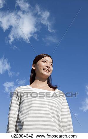 Young Woman Against Blue Sky View Large Photo Image Stock Image - Young Woman Against Blue Sky. Fotosearch