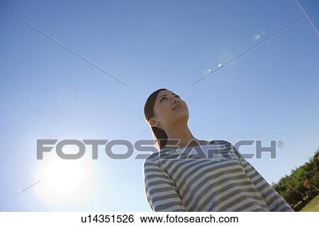 Young Woman Against Blue Sky View Large Photo Image Stock Photograph - Young Woman Against Blue Sky. Fotosearch