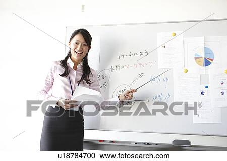 Stock Image - Young Woman Giving Presentation. Fotosearch