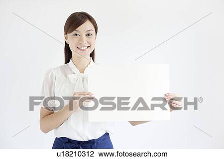 Stock Image - Young Woman Holding Up Blank Message. Fotosearch