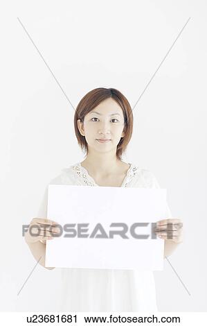 Stock Image - Young Woman Holding Up Blank Message. Fotosearch