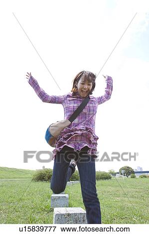Stock Photo - Young Woman Jumping. Fotosearch