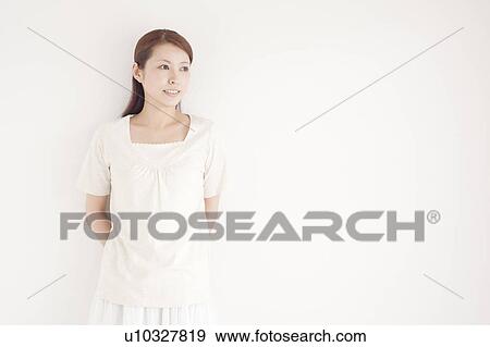 Stock Photo - Young Woman Leaning Against Wall. Fotosearch