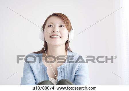 Young Woman Listening To Headphones View Large Photo Image Picture - Young Woman Listening To Headphones. Fotosearch