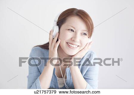 Young Woman Listening To Headphones View Large Photo Image Stock Photo - Young Woman Listening To Headphones. Fotosearch