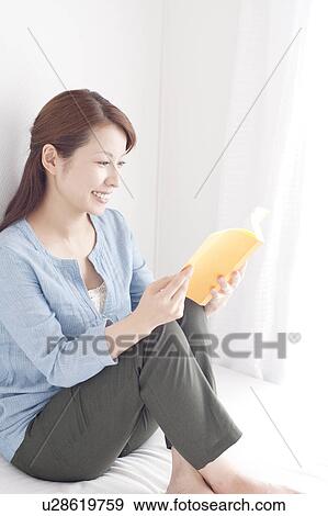 Stock Photo - Young Woman Reading Book. Fotosearch