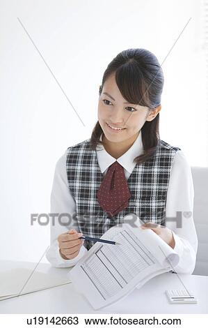 Stock Image - Young Woman Showing Data. Fotosearch