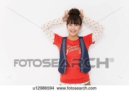 Young woman touching her hair View Large Photo Image Picture - Young woman touching her hair. Fotosearch