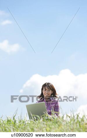 Young Woman Using Laptop in Park View Large Photo Image Stock Image - Young Woman Using Laptop in Park. Fotosearch