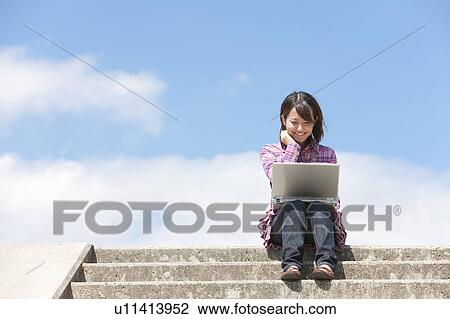 Young Woman Using Laptop on Steps View Large Photo Image Stock Image - Young Woman Using Laptop on Steps. Fotosearch