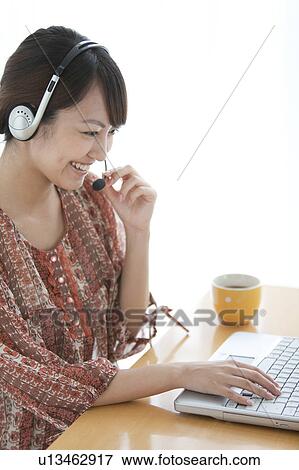 Stock Photo - Young Woman Using Laptop. Fotosearch