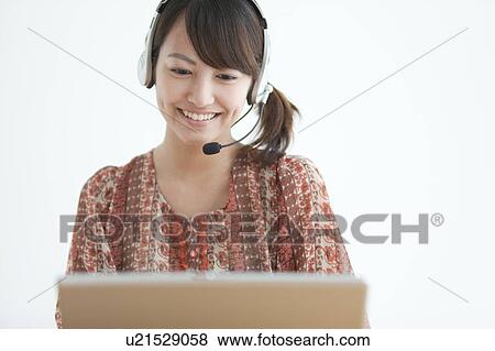 Stock Photo - Young Woman Using Laptop. Fotosearch
