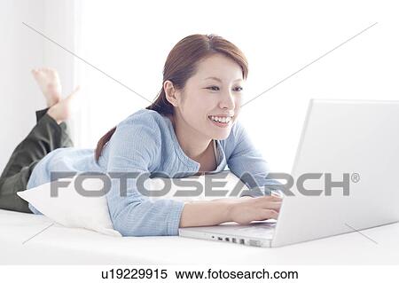 Stock Photography - Young Woman Using Laptop. Fotosearch
