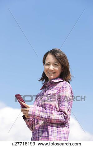 Young Woman Using Mobile Phone View Large Photo Image Stock Photo - Young Woman Using Mobile Phone. Fotosearch