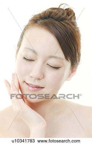 Stock Image - Young Woman with Eyes Closed Touching Her Face. Fotosearch