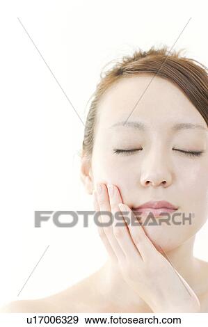 Young Woman with Eyes Closed Touching Her Face View Large Photo Image Stock Photo - Young Woman with Eyes Closed Touching Her Face. Fotosearch