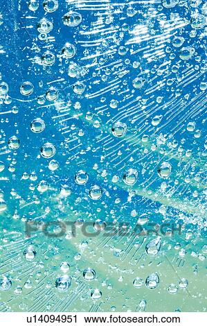 Stock Image - Air Bubbles in Frozen Water. Fotosearch