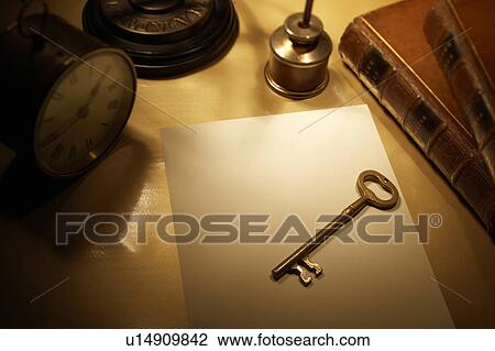 Stock Image - Antique key on desk. Fotosearch