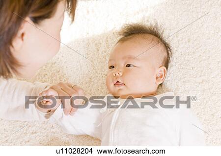 Baby and mother looking at each other View Large Photo Image Picture - Baby and mother looking at each other. Fotosearch