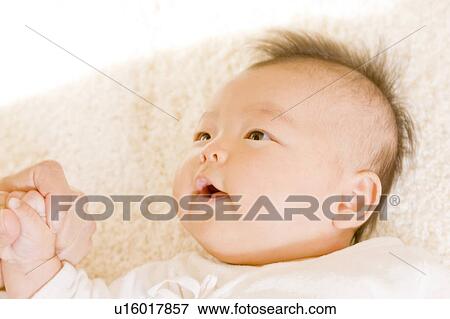 Stock Photo - Baby and mother looking at each other. Fotosearch