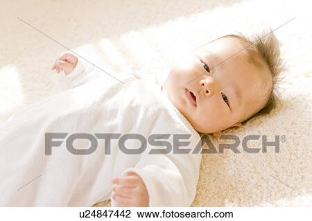 Baby lying on back View Large Photo Image Stock Image - Baby lying on back. Fotosearch