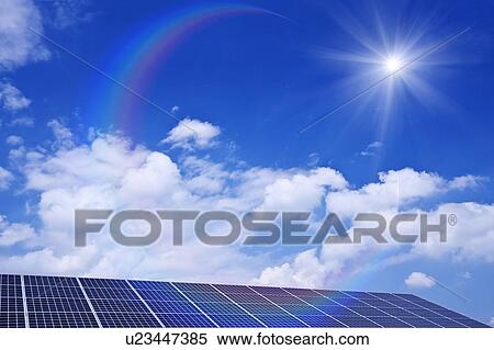 Stock Photography - Blue Sky and Sun Over Solar Panels. Fotosearch