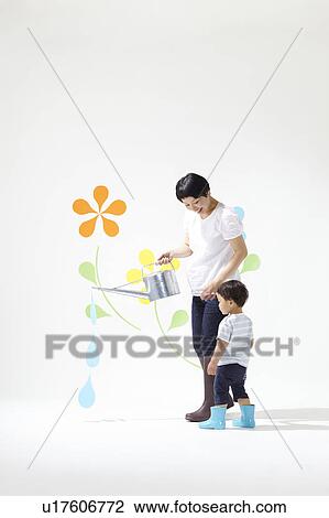 Stock Image - Boy and Mother Watering Plants. Fotosearch