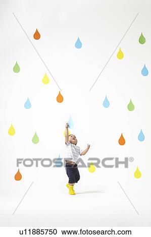 Stock Image - Boy Catching Raindrop. Fotosearch