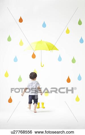 Stock Photograph - Boy in Colourful Rain. Fotosearch