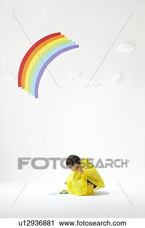 Stock Image - Boy Playing in Rain. Fotosearch