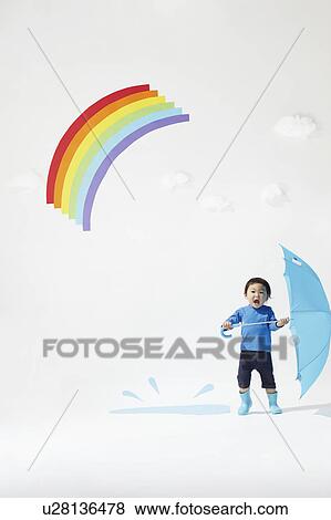 Stock Photo - Boy Playing Under Rainbow. Fotosearch