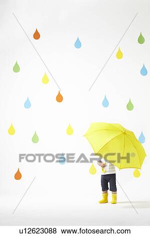 Boy Under Umbrella in Colourful Rain View Large Photo Image Stock Photo - Boy Under Umbrella in Colourful Rain. Fotosearch