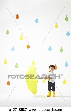 Boy Under Umbrella in Colourful Rain View Large Photo Image Stock Photo - Boy Under Umbrella in Colourful Rain. Fotosearch