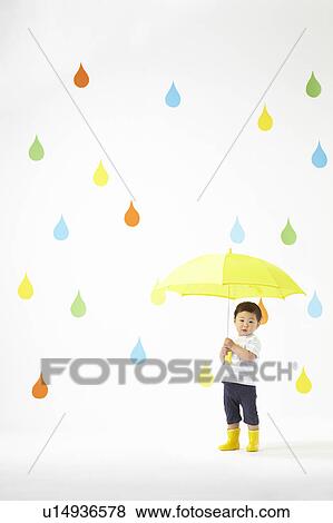 Stock Photo - Boy Under Umbrella in Colourful Rain. Fotosearch