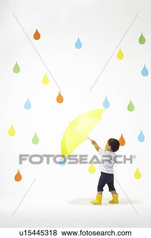 Stock Photo - Boy Under Umbrella in Colourful Rain. Fotosearch