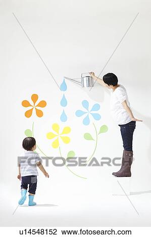 Stock Image - Boy Watching Mother Watering Plants. Fotosearch