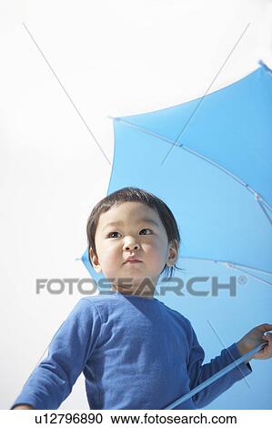 Stock Image - Boy with an umbrella. Fotosearch