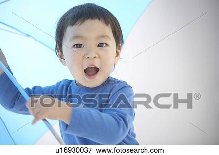 Boy with an umbrella View Large Photo Image Stock Photo - Boy with an umbrella. Fotosearch